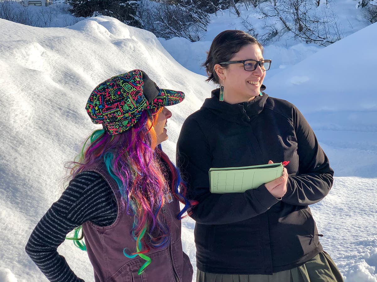 Aurora and Meredith discussing grant writing in the snow